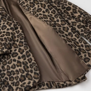 Detail shot of leopard print faux fur texture with smooth brown lining and quality stitching