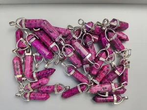 Close-up of bulk purple speckled stone hexagonal point pendants with silver metal clasps