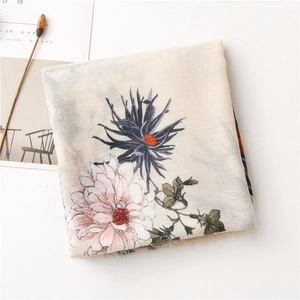 Detailed view of floral cotton linen scarf with soft pink flowers and fringe edges