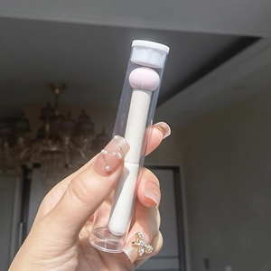 Pink mushroom head concealer brush with white handle in a clear protective storage tube