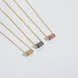 Close-up of sparkling rhinestone cylinder pendants in gold, black, and rose gold finishes
