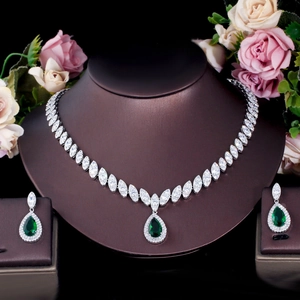 Close-up of bridal emerald green pear-cut zircon necklace and earrings set with white stones