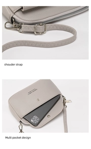 Close-up of grey lychee leather crossbody bag with adjustable strap and front phone pocket