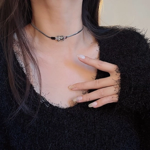Close-up of a silver snake chain choker featuring a minimalist belt buckle pendant design