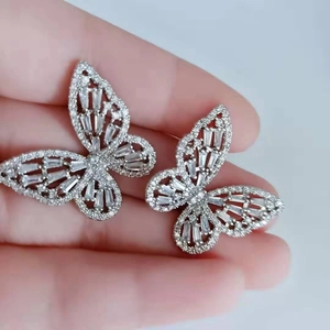 Detailed view of hollow butterfly earrings featuring sparkling cubic zirconia stones