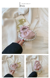 Detailed view of pink pleated mini bag with oversized pearl handle and gold chain strap