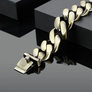 Macro shot of bronze Cuban chain bracelet with brushed matte finish and square buckle