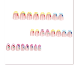 Detail of short round press-on nails with cute cherry fruit patterns and plaid designs