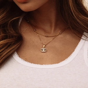Double-layered 925 silver evil eye pendant necklace with gold beads on model