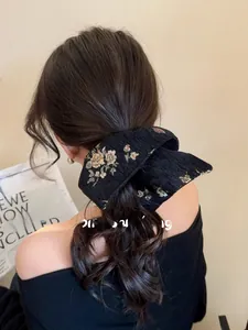 Detail of floral jacquard hair scrunchie worn in a half-up hairstyle for women