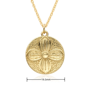 Detail shot of a 19.5mm gold sun tarot pendant with matte texture and floral pattern