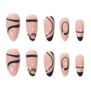 Almond shaped nude pink false nails with abstract black lines and minimalist patterns