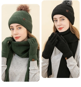 Winter knit set featuring a dark green and black hat, scarf, and warm gloves with pom-pom
