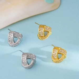 Elegant twisted hoop earrings in gold and silver finish with pavé set zircon stones