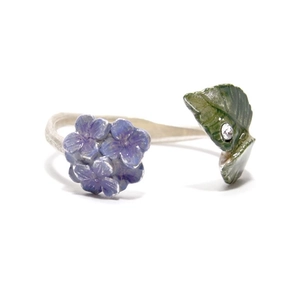 Detail of flower cluster ring with purple petals and a green leaf with small zircon