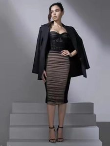 Fashionable three-piece set with black velvet corset, pleated midi skirt and oversized blazer