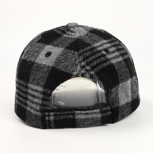 Detail view of the back of a grey plaid wool baseball cap with velcro closure
