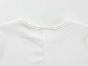 Macro shot of white athletic T-shirt featuring precise neckline stitching and knit texture