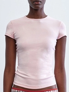 Detail of pink slim-fit crop t-shirt showing cotton fabric and classic round neckline
