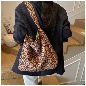 Detail of leopard print tote bag with beaded pendant in a stylish vintage autumn setting