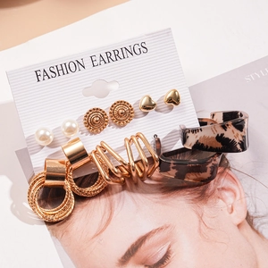 Detail view of 12-piece fashion earring set with faux pearls and geometric gold designs