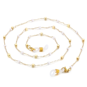 Golden titanium steel eyewear chain with white pearls and square charms on white background