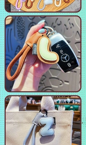 Detail of colorful alphabet leather keychain with braided rope and metal spring clasp