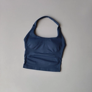 Detailed close-up of seamless halter yoga top featuring ribbed side panels and navy fabric