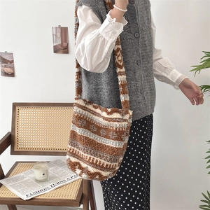 Large capacity brown patterned plush lamb wool shoulder bucket bag on model in room