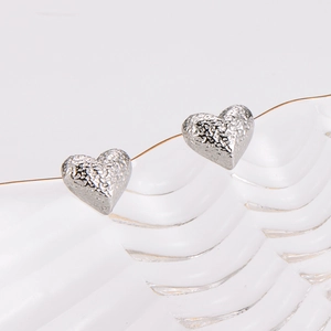 Stylish heart shaped stainless steel stud earrings with hammered metal texture finish