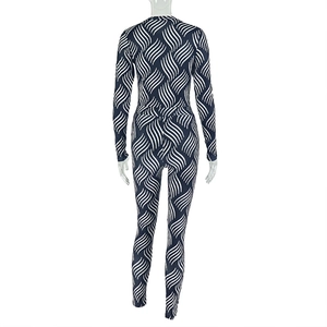Detail view of the back of a navy blue jumpsuit with white wave pattern and long sleeves