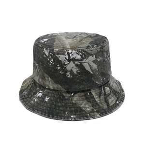 Detailed close-up of a washed camo bucket hat with realistic dry leaf pattern