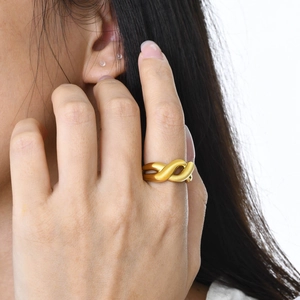 Polished 18K gold stainless steel knotted open ring for women on model finger