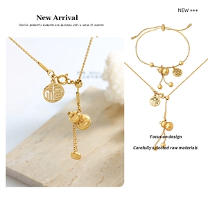 Detail of gold titanium steel necklace and bracelet set with gourd and Fu character charms
