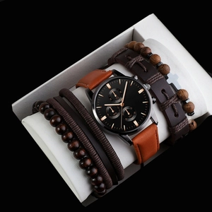 Macro shot of men's brown leather quartz watch and wooden bead bracelet set in a gift box