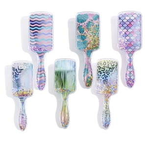 Detail view showing six colorful glitter hair brushes with floating sequins and stars