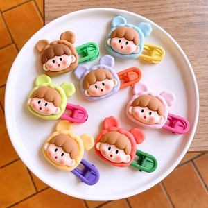 Flat lay of colorful resin cartoon hair clips arranged neatly on a white display plate