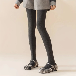 Detailed texture of thick grey cotton ribbed leggings paired with plush Mary Jane shoes