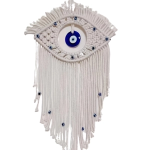 Handmade Bohemian macrame wall hanging featuring a blue evil eye design with tassels