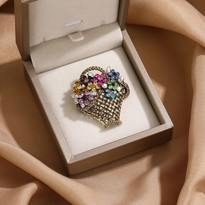 Vintage flower basket brooch with colorful rhinestones in an elegant jewelry box