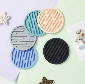 Flat lay of colorful 10cm round silicone coasters with non-slip grooved texture