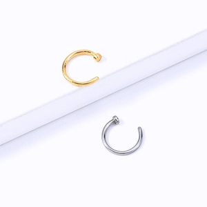 Detailed close-up of minimalist gold and silver stainless steel U-shaped nose rings