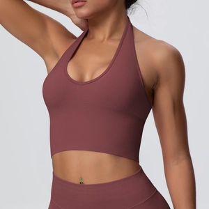 Detail of burgundy ribbed seamless sports bra and high-waisted leggings set for gym yoga