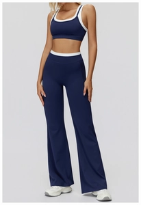 Detail of high-waist flared yoga pants and racerback top with contrast piping trim