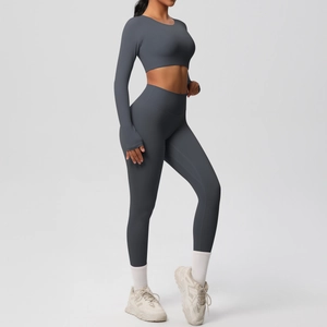 Detail of high-stretch dark grey yoga set with long sleeve crop top and high waist leggings