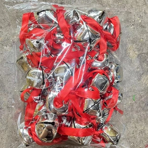 Silver Christmas bell ornaments with red ribbon and Believe engraving in a package