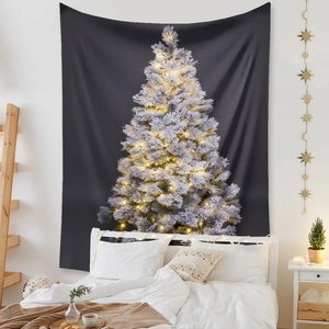 Detail of Christmas tree tapestry with warm golden lights on a dark background