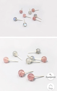 Macro detail of spherical S999 sterling silver stud earrings with natural crystal stones