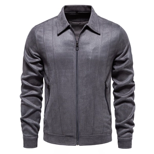 Macro detail of men's grey suede jacket featuring turn-down collar and smooth zipper closure