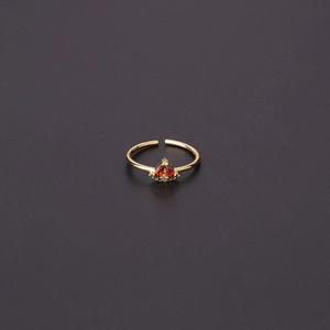 Macro detail of adjustable gold ring with red and green zircon strawberry pattern